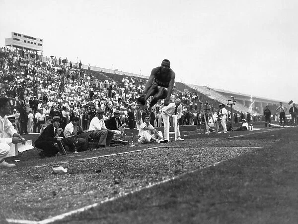 JAMES JESSE OWENS (1913-1980). American athlete. Owens in the midst of his broad jump leap, which was responsible for one of the four gold medals he won and three track-and-field records he set at the 1936 Berlin Olympic Games