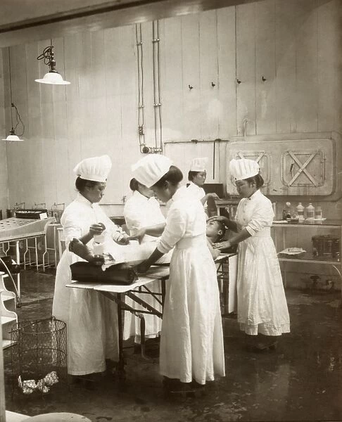 JAPAN: HOSPITAL, c1905. Nurses tending to a patient in an operating room at a hospital in Japan