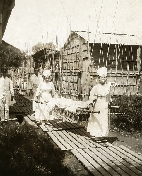 JAPAN: NURSES, c1905. Japanese nurses carrying a patient on a stretcher. Photograph