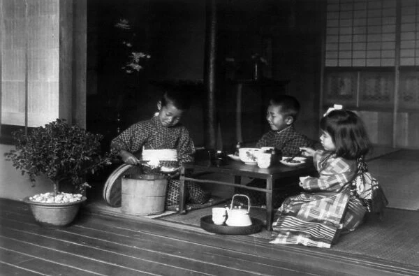 JAPAN: TEA PARTY. Three children having a tea party around a table in Japan. Photograph