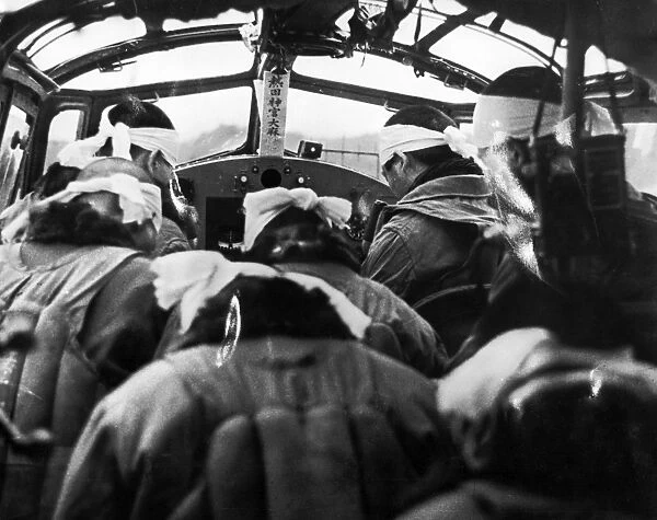Japanese pilots bow their heads in a Shinto ceremony before take-off, at the Nicobar Islands in the South Pacific. Photograph, Summer 1942
