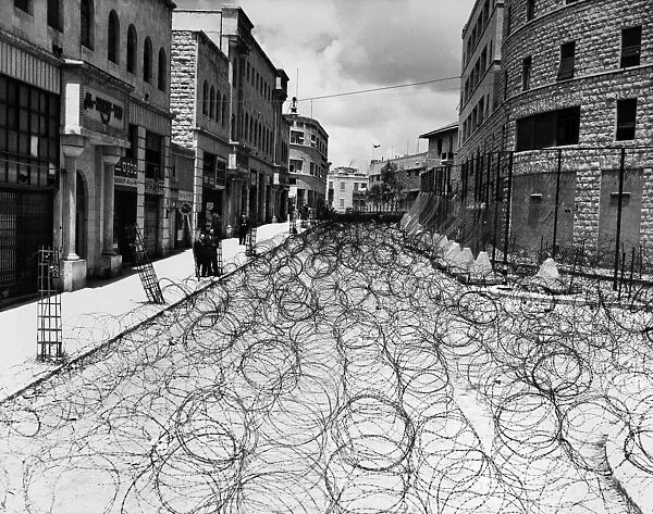 JERUSALEM: STREET, 1948. Princess Mary Avenue in Jerusalems Old City, filled with barbed wire to keep Arabs and Jews from interacting with each other, as the British Mandate of Palestine was terminated, May 1948