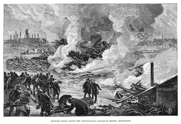JOHNSTOWN FLOOD, 1889. Burning ruins above the Pennsylvania Railroad Bridge, Johnstown