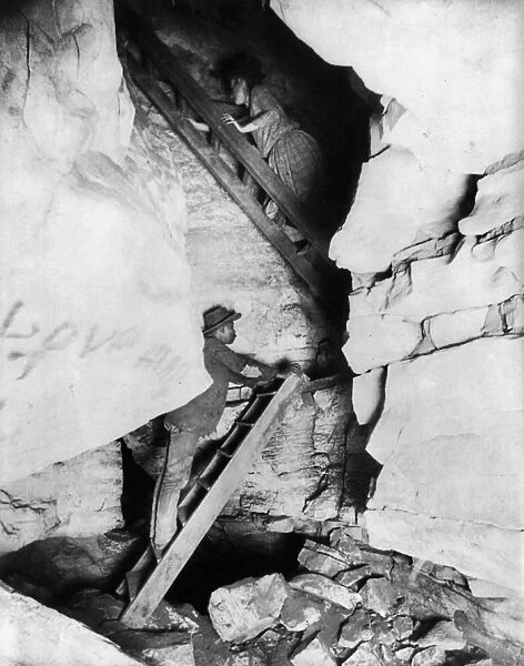 KENTUCKY: MAMMOTH CAVE. A man and woman climbing ladders in Mammoth Cave in Kentucky