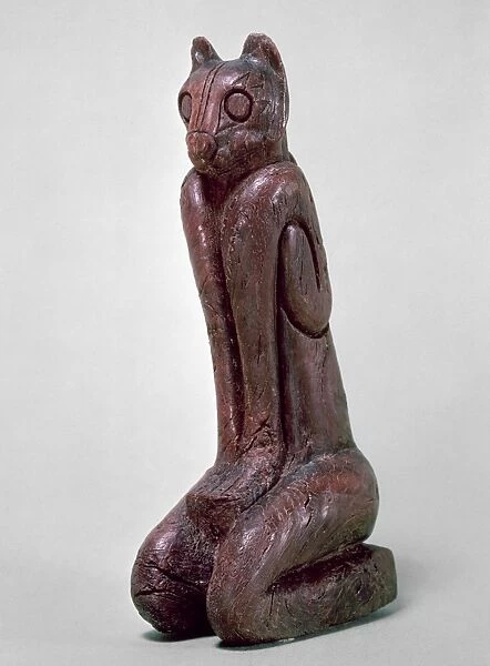 KEY DWELLERS: CAT FIGURE. Seated cat figure, carved wood sculpture from the Key Dweller culture of Key Marco, Florida, c1000-1600 A. D. Height: 15. 2 cm