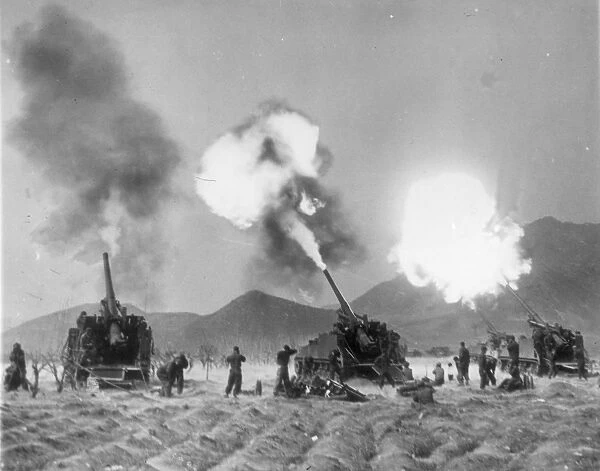 KOREAN WAR, 1951. United Nations artillerymen firing Eighth Army 155mm guns against advancing communist troops, 1951