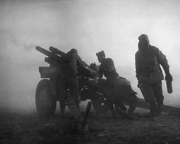 KOREAN WAR: ARTILLERY. U. S. Marine artillerymen firing in the fog on a North Korean concentration on the fighting front, early March 1951
