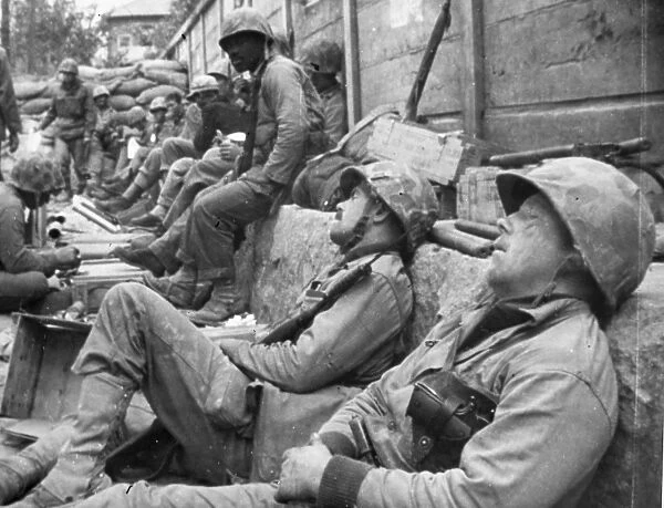 KOREAN WAR: U. N. TROOPS. Exhausted United Nations troops take a rest during a lull in fighting near Seoul, South Korea, September 1950