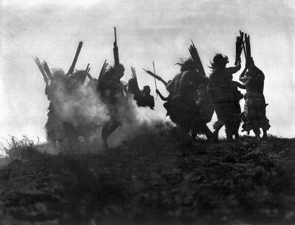 KWAKIUTL DANCERS, c1914. Kwakiutl dance to restore an eclipsed moon. The men dance in a circle around a smoking fire, to cause a sky creature which was believed to have swallowed the moon, to sneeze and restore the moon to the sky. Photograph by Edward