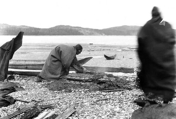 KWAKIUTL: FIRE, 1894. A Kwakiutl Native American on the coast of Vancouver Island