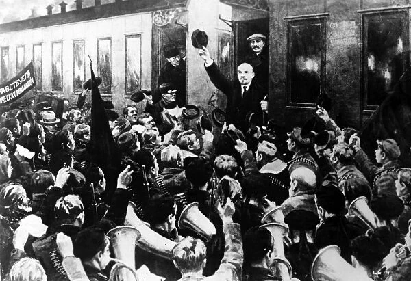 LENIN AT FINLAND STATION. The arrival of Russian Communist leader Vladimir Ilich Lenin (facing crowd with hat raised) at the Finland Station in Petrograd, April 1917. Joseph Stalin, who was not actually present at the event, is fictitiously depicted standing behind Lenin. Soviet painting, c1930s