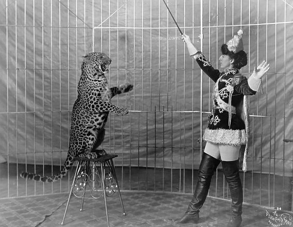 LEOPARD TRAINER, c1906. Big cat trainer Dolores Vallecita and a leopard. Photograph