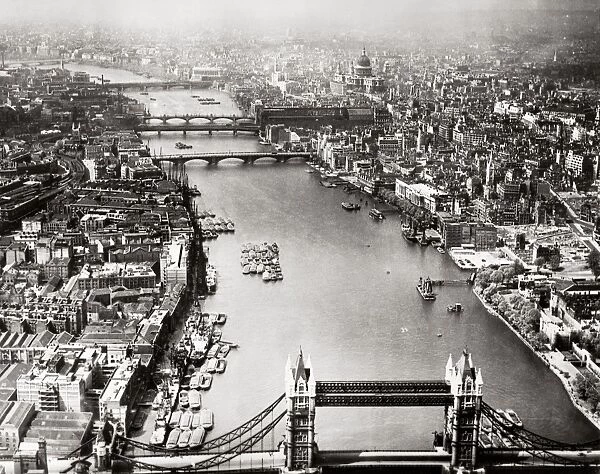 LONDON: AERIAL VIEW, 1946. Aerial view of London, England, looking west along the Thames River from the Tower Bridge (foreground). Photographed in 1946