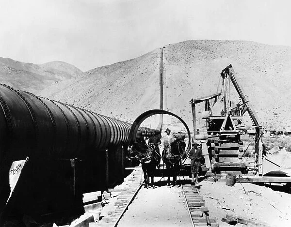 LOS ANGELES AQUEDUCT. A mule team hauling a section of pipe during the construction of a siphon