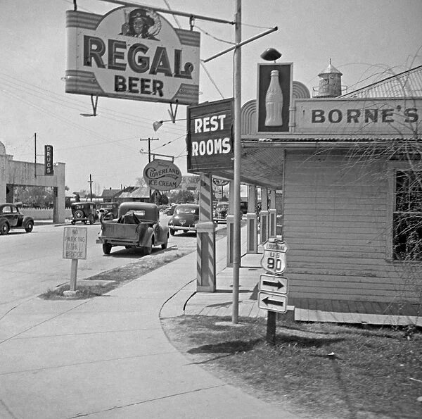 LOUISIANA, 1943. A store and street signs along U. S. Highway 90 in Raceland, Louisiana