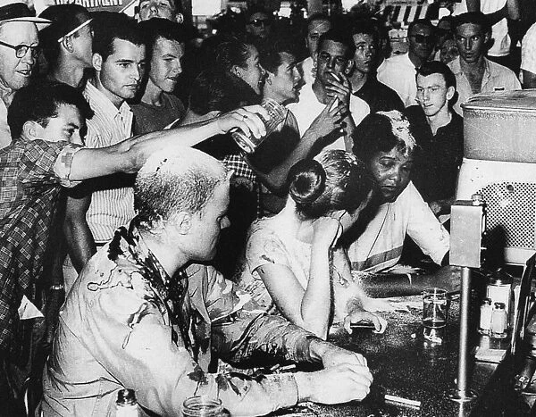 LUNCH COUNTER SIT-IN, 1963. Three demonstrators at a lunch counter sit-in in Jackson, Mississippi, are smeared with ketchup, mustard and sugar by integration opponents, 1963