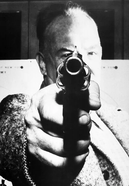 MAN AIMING REVOLVER AT YOU. American photograph, mid-20th century
