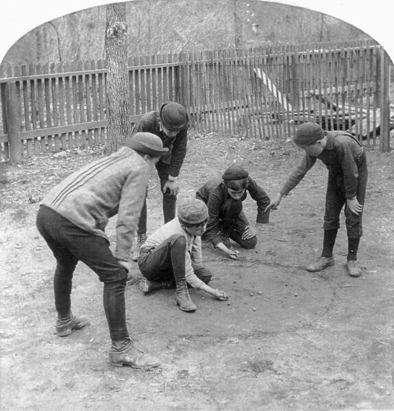 MARBLE GAME, c1891. Boys playing marbles. Stereograph, c1891