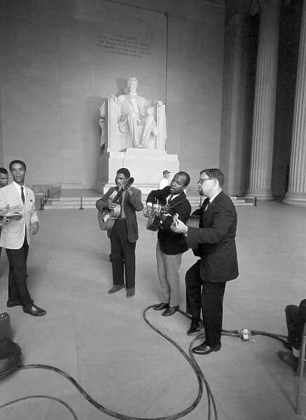 MARCH ON WASHINGTON, 1963. Men singing and playing guitars inside the Lincoln Memorial