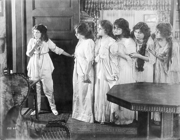 Marguerite Clark and other cast members in a scene from the silent film, 1916; American