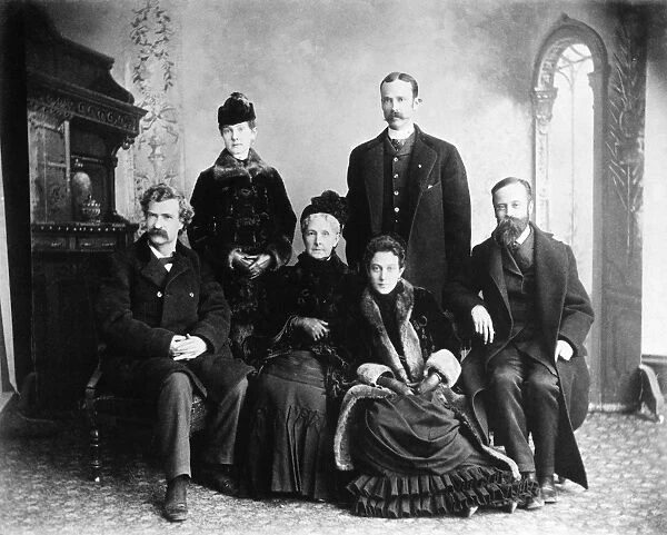 MARK TWAIN AND GEORGE WASHINGTON CABLE. Samuel Langhorne Clemens (left) and George Washington Cable (right) flanking the family of Erasmus Mason Moffett, Twains relatives by marriage: Widow Sarah M. Cox Moffett, daughters Lizzie (standing) and Ella, and son-in-law Valentine Surghnor, Lizzies husband. Photographed at Quincy, Illinois, 12 January 1885