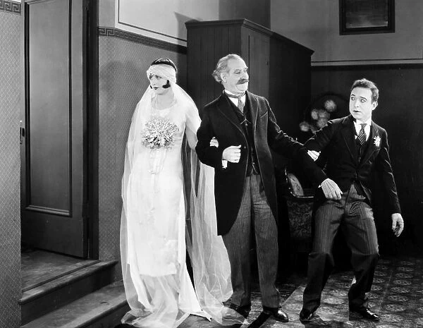 HIS MARRIAGE WOW, 1925. Natalie Kingston, William McCall, and Harry Langdon