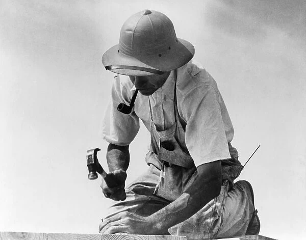 MARYLAND: CARPENTER, 1936. A carpenter at work in Greenbelt, Maryland. Photograph by Carl Mydans