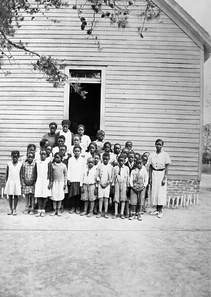 MARYLAND: SCHOOL, c1950. African American students with their teacher outside of a school