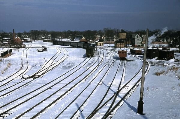 MASSACHUSETTS: RAILROAD. Train and several sets of railroad tracks in the snow in Massachusetts