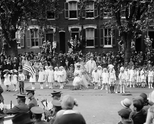 MAY DAY CEREMONY, 1925. Dorothy Zimmerman, as Spring, crowning Irma Sweeney as