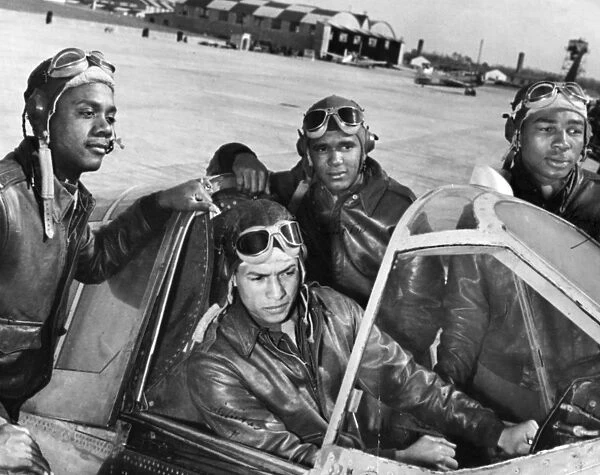 Members of the first group of African American pilots in the history of the U. S. Army Air Corps, identified standing left to right: Hicks, Clifton and Moody, with Williams at the control. Photograph, c1942