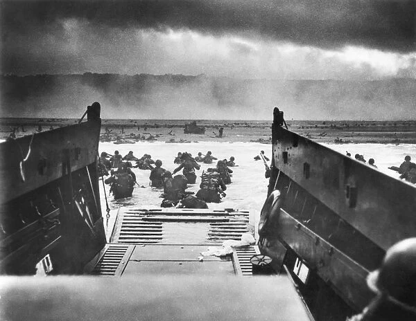 Men of Company E, 16th Infantry Regiment, 1st U. S. Infantry Division, landing on Omaha Beach, Normandy, France, from the landing craft USS Samuel Chase on D-Day, 6 June 1944. Photographed by U. S. Coast Guard Chief Photographers Mate Robert F. Sargent