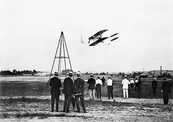 Men watching the flight of a biplane at Fort Myer, Virginia, 2 July 1909