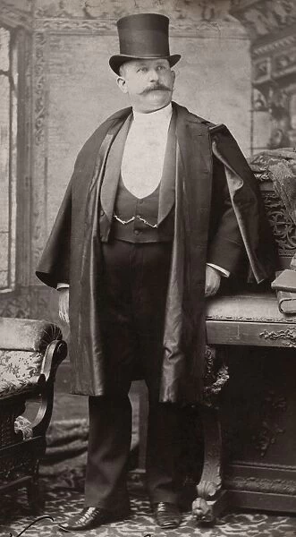 MENs FASHION, c1880. A portly unidentified gentleman showing off his suit and coat