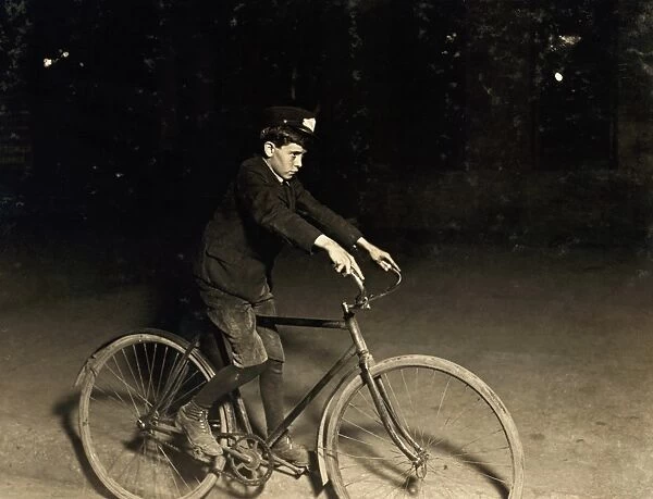 MESSENGER BOY, 1908. A messenger boy delivering telegraphs during the night in Indianapolis