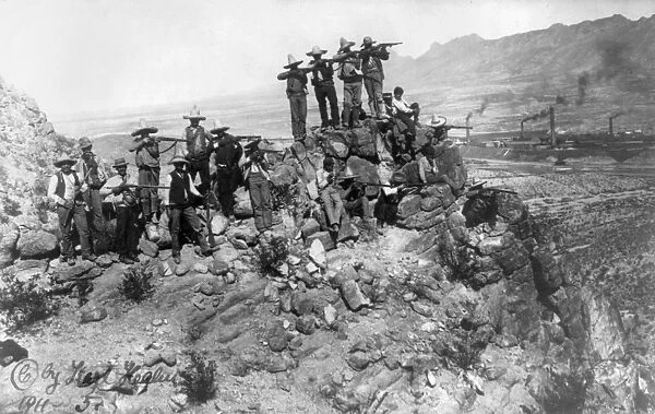 MEXICAN REVOLUTION, 1911. Mexican revolutionary troops aiming rifles from a mountain position