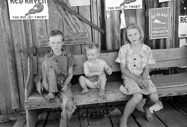MIGRANT CHILDREN, 1939. Children of agricultural day laborers sitting in front
