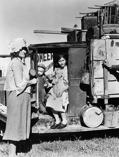 MIGRANT FAMILY, 1935. Drought refugees from Oklahoma looking for work in the pea