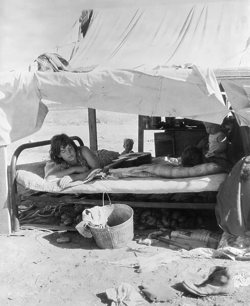 MIGRANT FAMILY, 1935. Oklahoma potato pickers family camping on the flats near Shafter