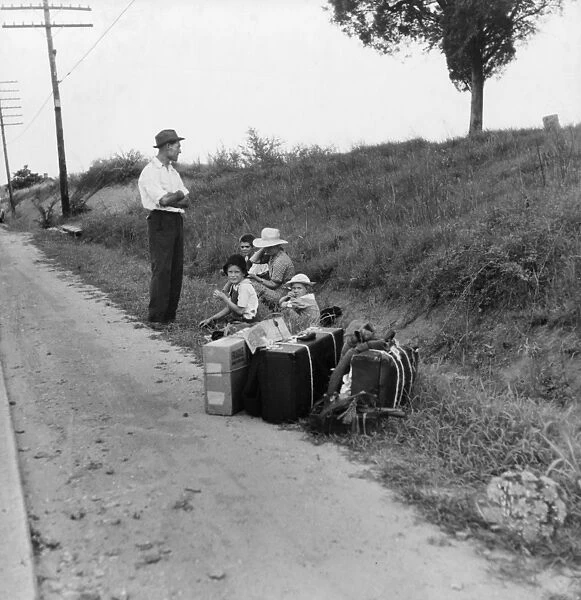 MIGRANT FAMILY, 1937. A family hitchhiking along the highway in Macon, Georgia