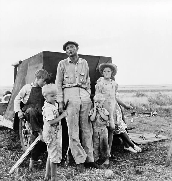 MIGRANT FAMILY, 1938. A migrant worker with his family camping on the outskirts of Perrytown