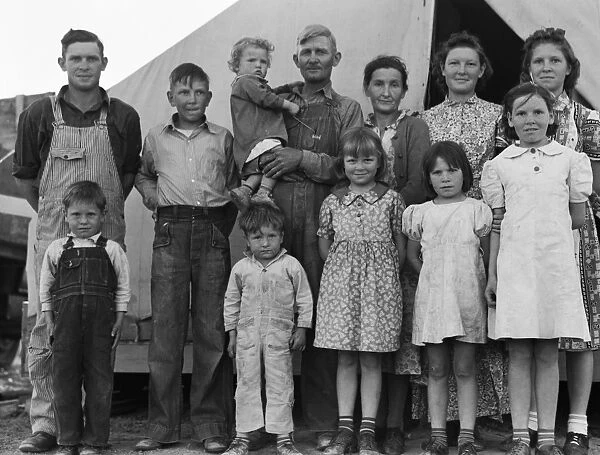 MIGRANT FAMILY, 1939. An ex-tenant farmer from Oklahoma with his wife and ten children