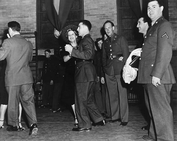 Military men and women dancing to the Knickerbocker Dance Band at a club in Fort Hamilton, Brooklyn, New York. Photograph, 1941