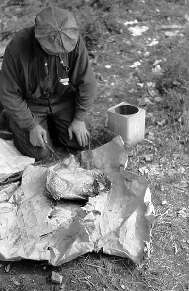MINNESOTA: HOBO, 1939. A man in hobo jungle killing a turtle to make soup in Minneapolis