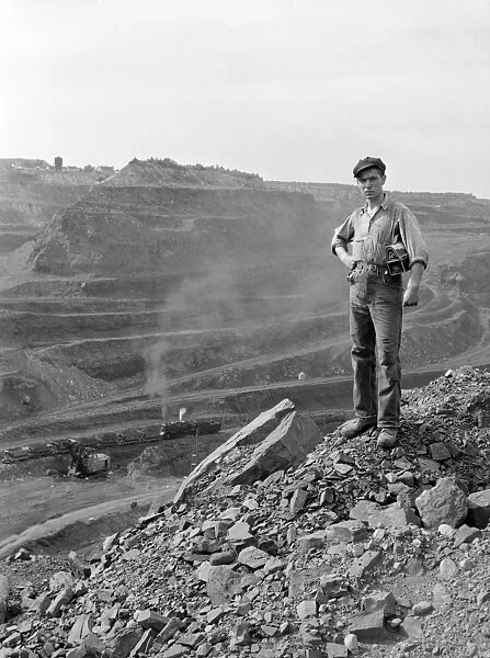 MINNESOTA: IRON MINE, 1941. Miner standing at at one end of the Hull-Rust-Mahoning iron pit