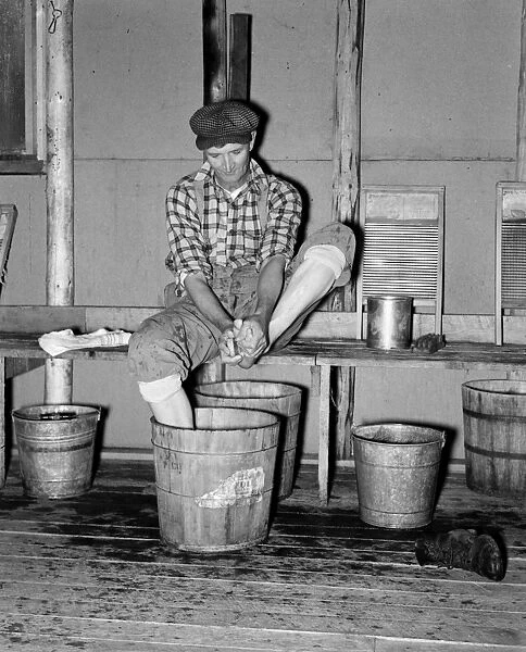 MINNESOTA: LUMBER CAMP, 1937. A lumberjack washing his feet in a lumber camp, near Effie