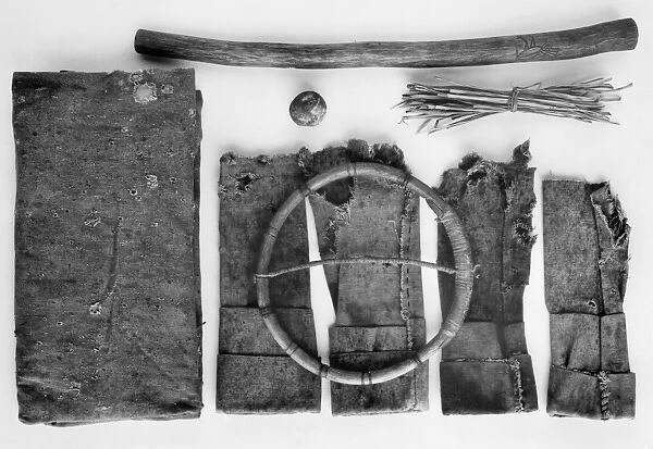 Moccasin game kit, with wooden hoop, stick, ball, and stack of twigs. Chiricahua Apache, from Oklahoma