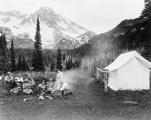 MOUNT RAINIER NATIONAL PARK. Camping party cooking over a campfire at Mount Rainier National Park