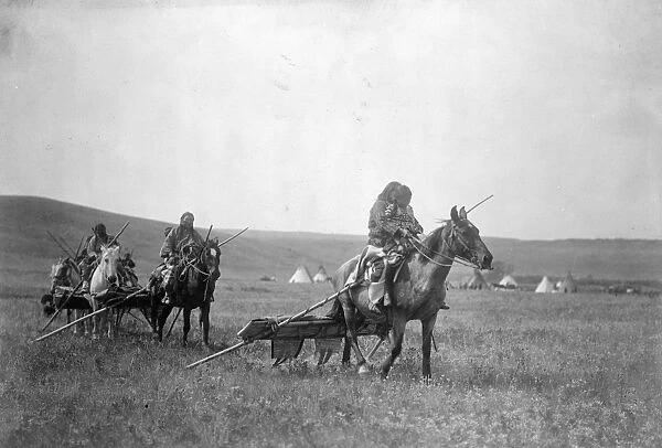 MOVING CAMP, c1908. Gros Ventre people moving camp with horses and travois in Montana