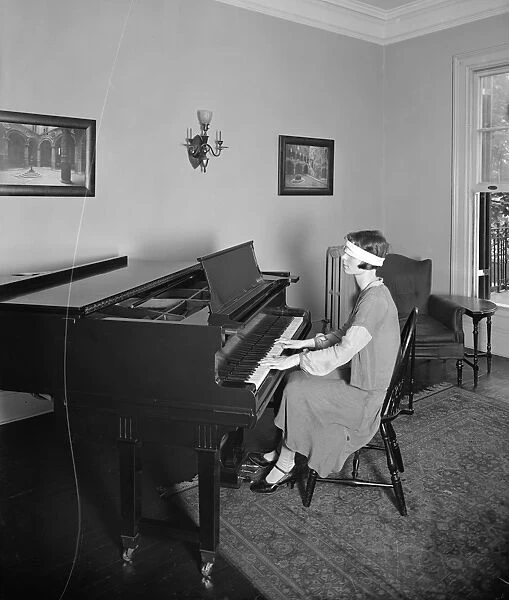 MUSIC CLASS, c1920. A student playing blindfolded at the Hendley-Kaspar School
